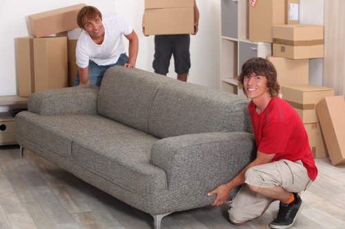 Homeowner preparing sofas and tables for furniture storage in Surrey
